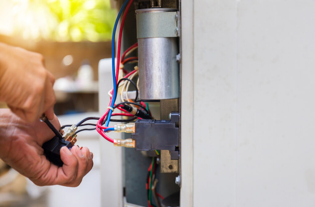 repairman fixing air conditioning system, changing magnetic contactor