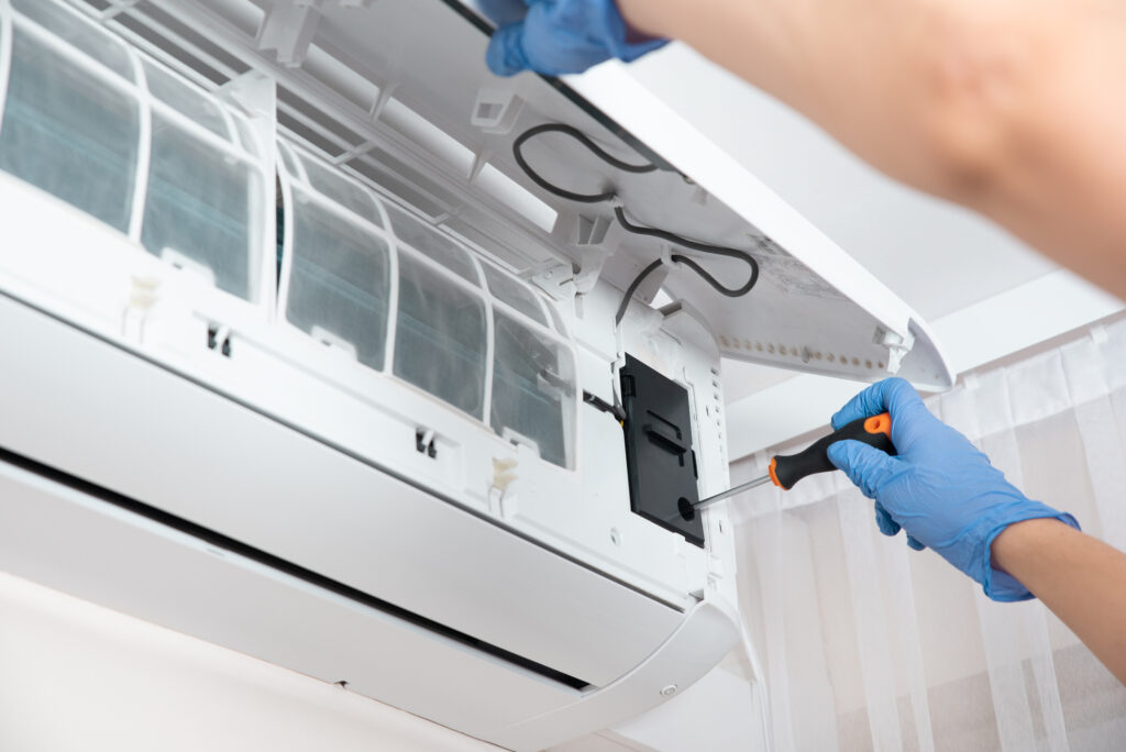 Installer screwing in part for ductless wall unit